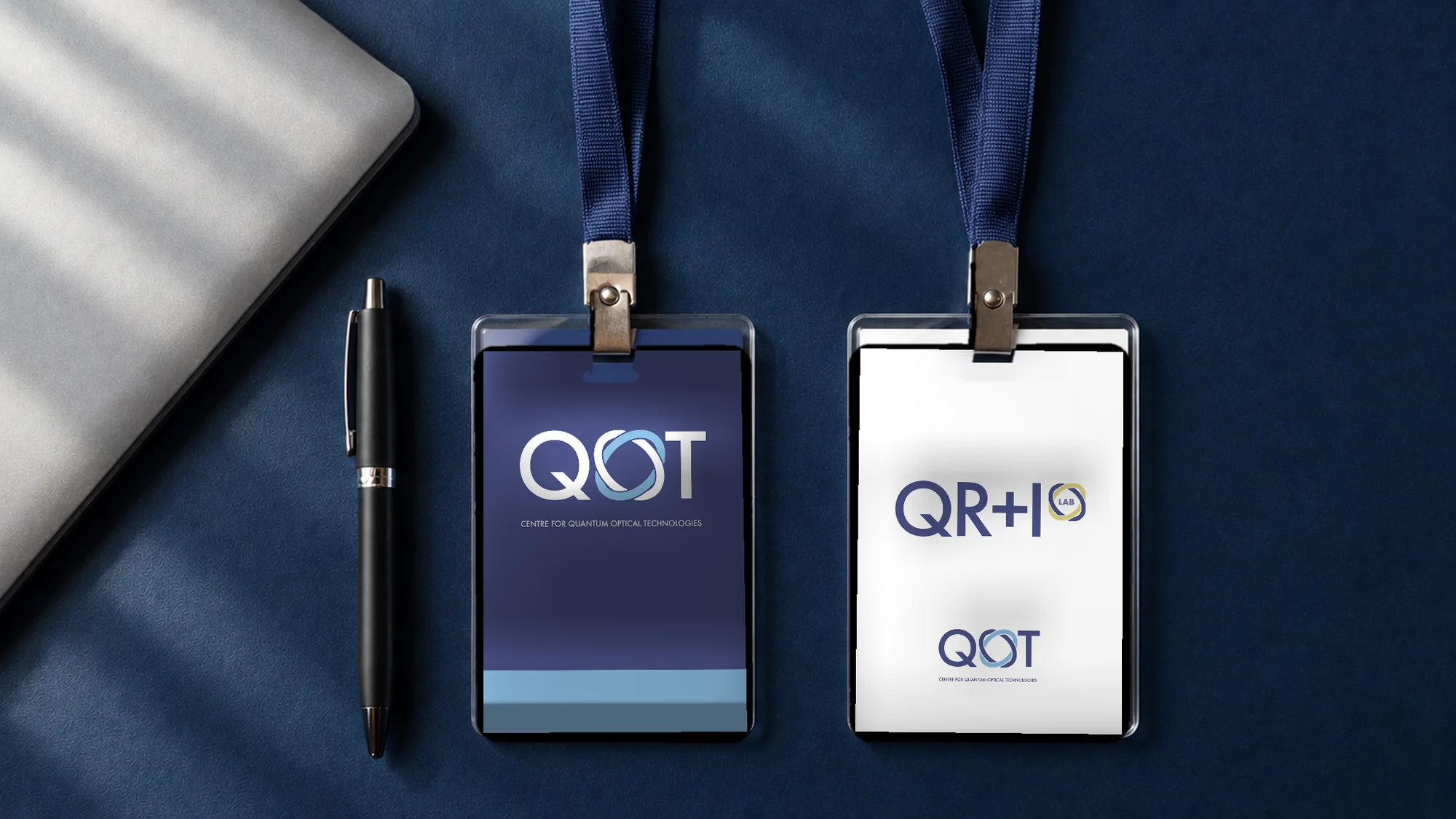 Badges: the centre in brand navy, the QR+I lab in white with its own logo