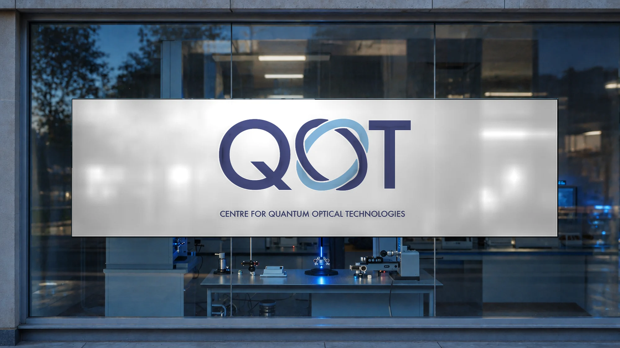 The QOT mark on the glass wall at the entrance to the optics lab